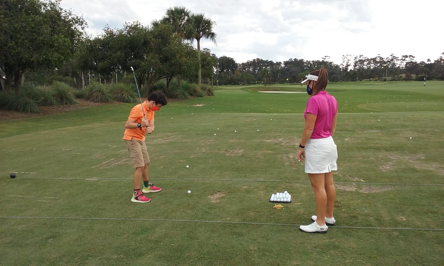 LPGA golfer Amelia Lewis instructs a young participant during the Tesori Family Foundation’s All-Star Kids Clinic.